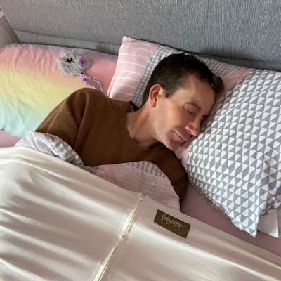 middle aged man lying in bed with fidgetbum compression sheet over the top