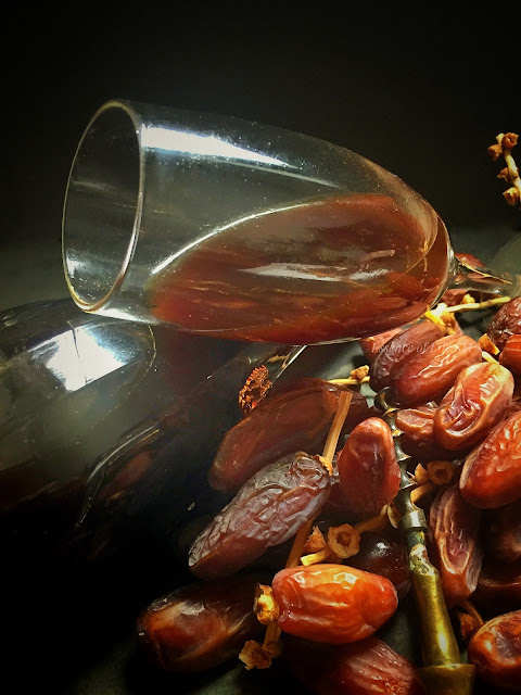 "Homemade Dates Wine: An enticing art of crafting exquisite beverage using fresh dates, sugar, and a touch of cinnamon."