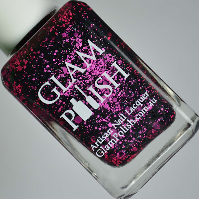 black nail polish with pink glitter in a bottle