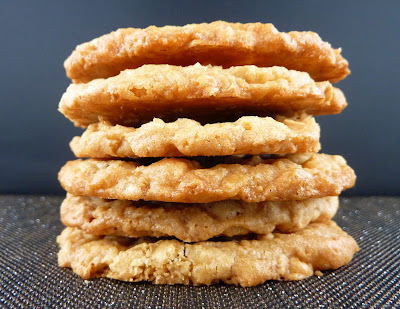 A stack of thin Ginger Oatmeal Crisps, photographed on a black sparkly mat