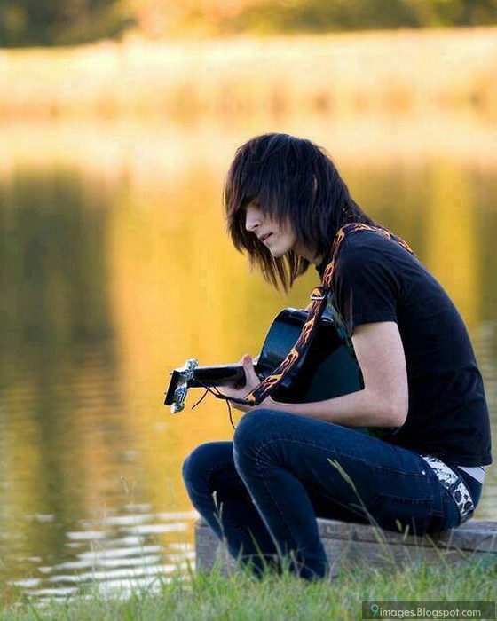 Emo boy alone playing guitar lake beautiful