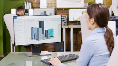 Architect making 3d building models on computer. architect holding blueprint.