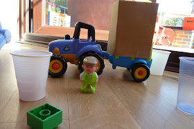 Child playing with ELC tractor toy