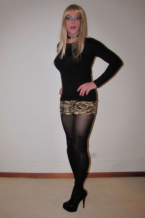 Stunning crossdresser in an animal print mini skirt with black pantyhose and heels