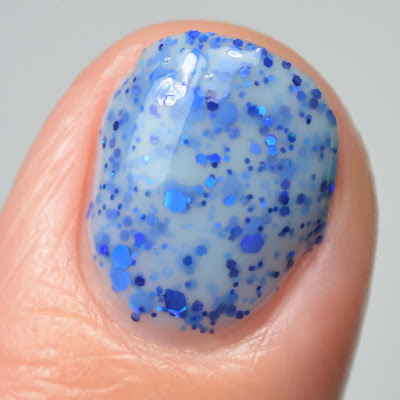 light blue nail polish with blue glitter close up swatch