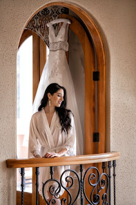 bride smiling before getting into dress