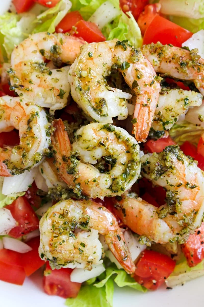 This 5 Minute Pesto Shrimp recipe is an easy, healthy, delicious way to prepare shrimp in just minutes! It's great served on a salad or as an accompaniment to steak. #shrimp #seafood