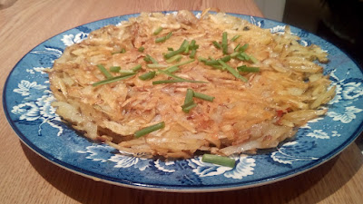 Plate-of-fried-grated-potatoes-sprinkled-with--fresh-chives