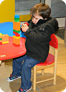 Small boy playing LEGO Duplo LEGOland Discovery Centre Manchester entrance