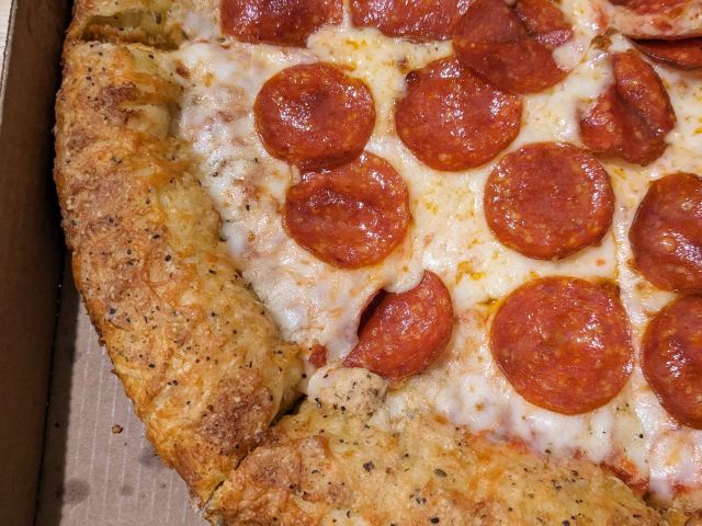 Papa Johns Garlic Epic Stuffed Crust Pizza end crust close-up top-down view.