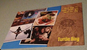 postcard with Turtle Bay written on it and pictures of beaches and happy people