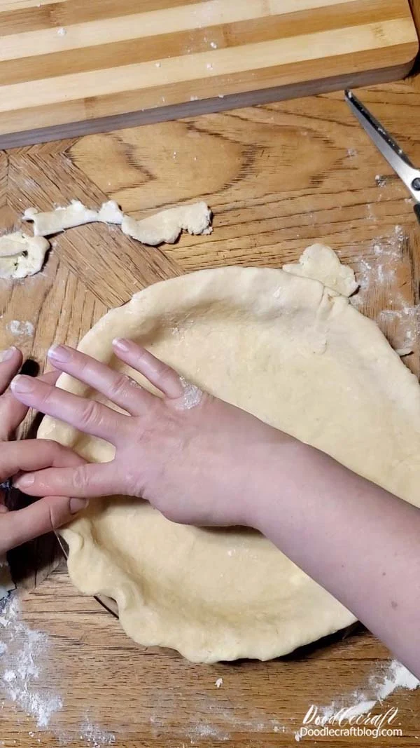 Finish off the edge of the pie by folding the edge under itself.   This makes a nice thick wavy edge.   If you don't like the thick edges, then use a knife and trim the crust to the edge of the pie dish before making the wavy edge...and it won't be as thick.   We like it thick here. 😉​