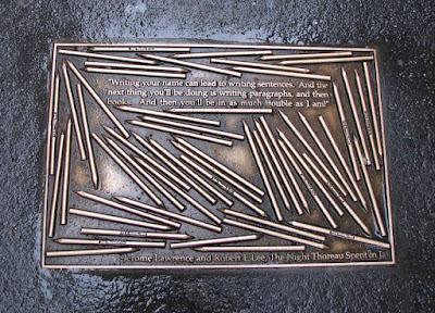 A bronze plaque on a sidewalk in New York