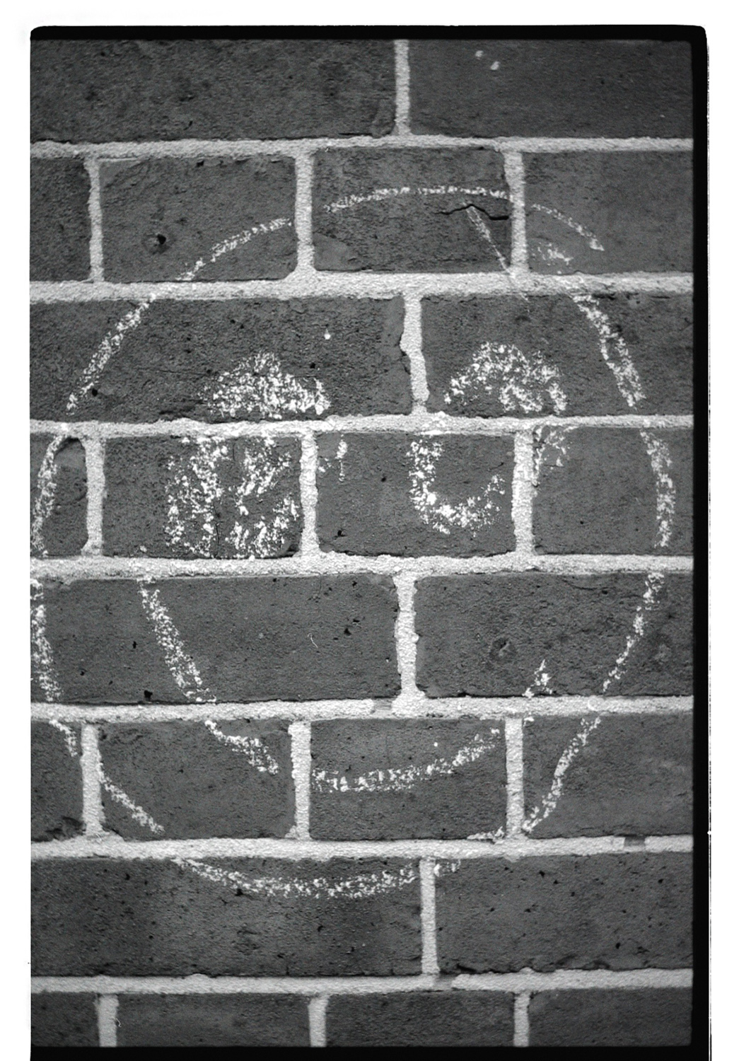 Smile on the Red Brick Wall - black and white