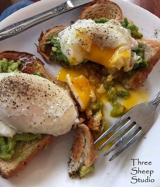 Avocado over toast with Poached Eggs.  Yum !