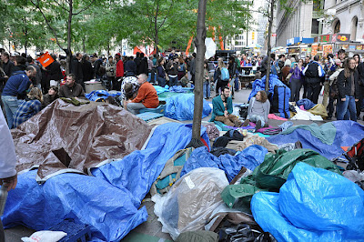 Photograph of protesters’ belongings covered with tarps