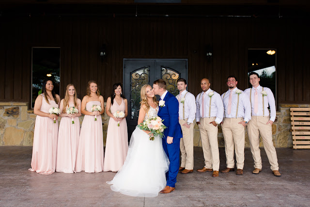 Something old, something new, something borrowed, something blue.  Sarah looked like she could have stepped right out of a Vogue Bridal magazine as she floated down the stairs in her beautiful wedding gown: a fitted, sleeveless, delicate lace bodice above a floor-length skirt, comprised of yards and yards of whimsical, white organza.  Tanner looked dapper in his royal blue suit, paisley tie, white rose boutonniere, and fancy, wood-grained leather shoes.  The bridesmaids and maid-of-honor wore individually designed, pale-pink, floor-length gowns and carried small bouquets similar to the bride’s pastel bouquet of beautiful, blush and ivory roses and ranunculus.      The SpringsEvent Venue in Edmond, OK, with its rustic and elegant accommodations, was the perfect setting For Sarah and Tanner’s intimate wedding and reception.  The morning began with First Looks for both the bride’s father, and then Tanner.  The clouds threatened rain throughout the morning—and almost drenched the bride and her maids during the picture-taking for the wedding party—but miraculously cleared up for the outdoor wedding nuptials.  The wedding couple were blessed to have so many people who traveled from throughout the country to celebrate their special day.   Sarah and Tanner agreed that their two favorite parts of the day were “getting to see each other during the first look, and then the actual wedding when we said our vows.”  Sarah said that during the first look, “we were able to spend those precious moments focusing on each other without all the hustle and bustle around us.”  After months of preparation and planning, she said, “the vows were also our favorite because we were finally getting married!”  Sarah’s suggestions to future brides, now that she has experienced her own wedding:  "Each and every moment is special:  getting ready, the first looks, walking down the aisle, the vows, the cake cutting, the dancing…take a moment or two to just slow down and take it all in…you’ll be glad you did!"  It was my pleasure to capture these beautiful memories for Sarah, Tanner and their families that will last forever.  For more information about my Wedding Packages, please visit my Weddings page on my website, www.michellevalantinephotography.com. 