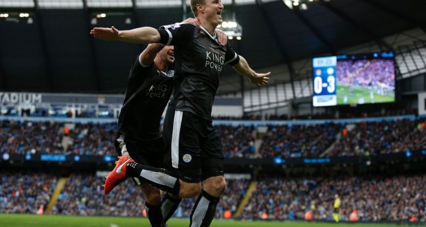 Leicester City’s Robert Huth (R) celebrates scoring his team’s third goal at the Etihad Stadium Photograph: / AFP / Adrian Dennis