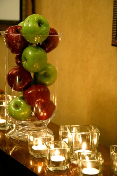 A mix of apples and candles makes a contemporary centerpiece
