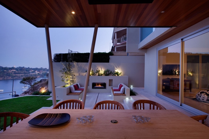 Wooden table in Modern backyard by Ritz Exterior Design