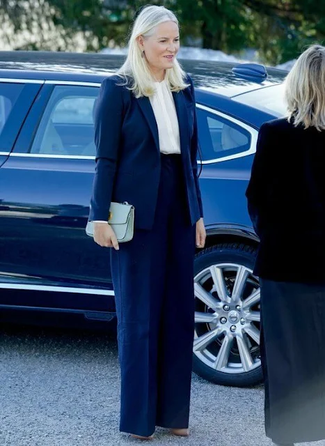 Crown Princess Mette-Marit wore a Banora white ivory silk blouse by Hugo Boss, and a black navy suit by Max Mara