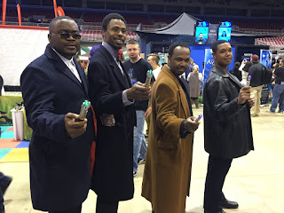 Photo of cosplayers dressed as the 9th, 10th, 11th, and 12th Doctors.