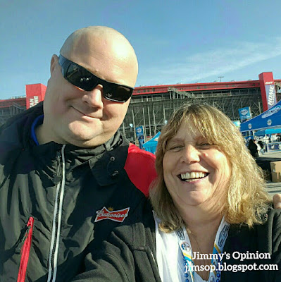 My wife Cindy posing at the car race with a Budweiser representative