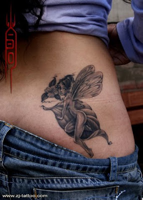 a fairy tattoo design on the lower back