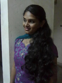 Homely looking Tamil girl showing off her long hair.