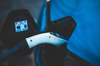 Electric vehicle being charged at charging station