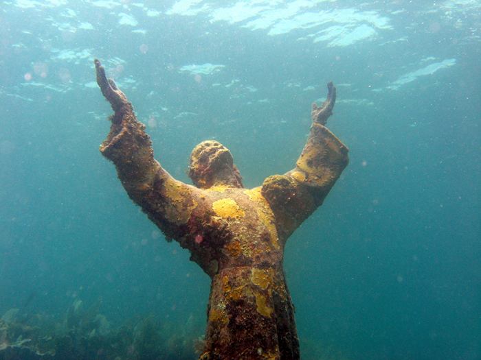 Christ of the Abyss is a submerged bronze statue of Jesus, of which the original is located in the Mediterranean Sea off San Fruttuoso between Camogli and Portofino on the Italian Riviera. It was placed in the water on 22 August 1954 at approximately 17 metres depth, and stands c. 2.5 metres tall. Various other casts of the statue are located in other places worldwide, both underwater and in churches and museums. The sculpture was created by Guido Galletti after an idea of Italian diver Duilio Marcante. The statue was placed near the spot where Dario Gonzatti, the first Italian to use SCUBA gear, died in 1947. It depicts Christ offering a blessing of peace, with his head and hands raised skyward.