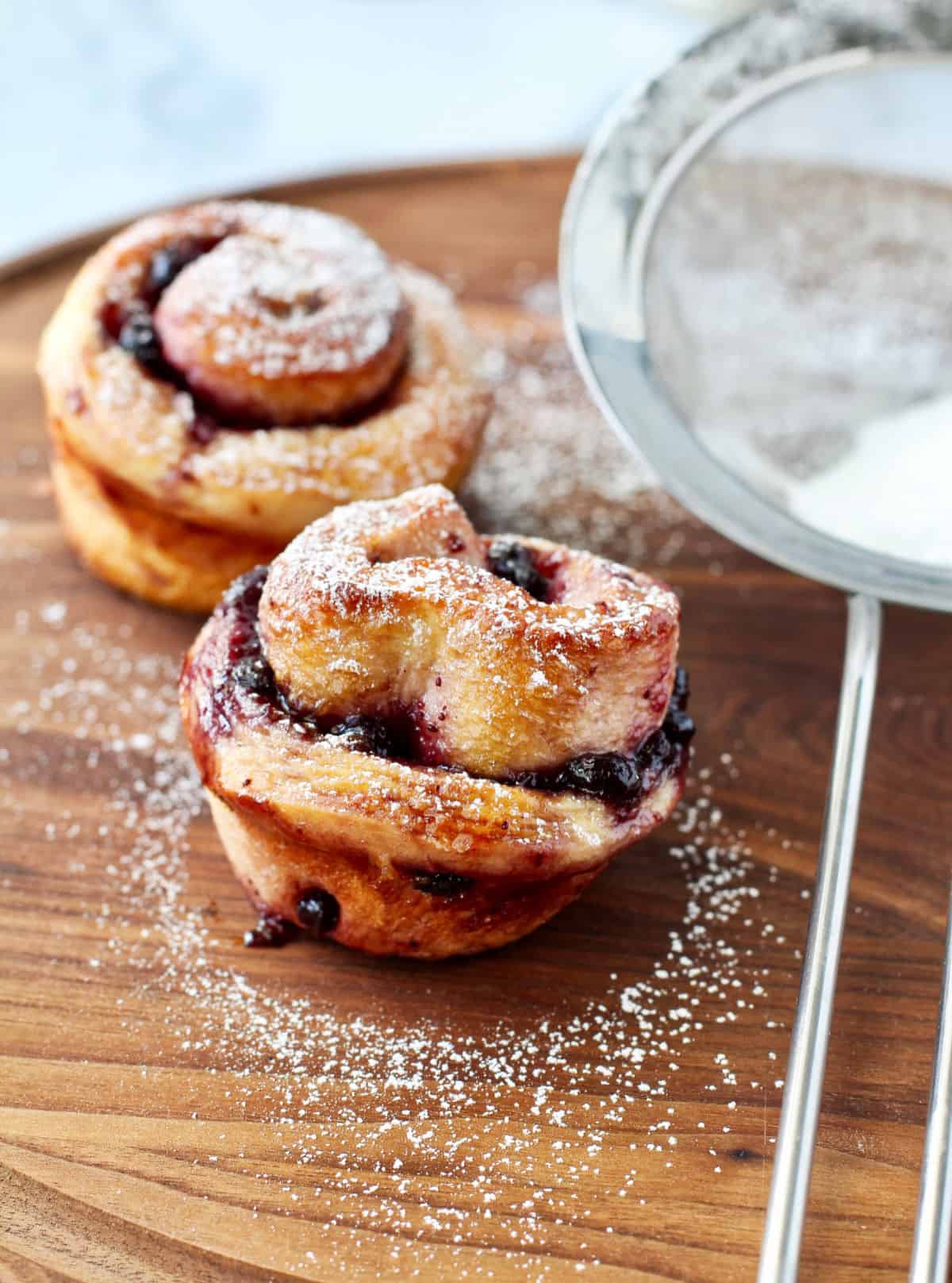 Pomegranate and Blueberry Jam Milk Buns on a wooden board.