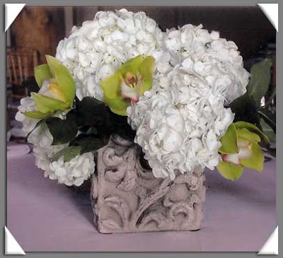 Flower Centerpiece with White Hydrangeas Cymbidium Orchids and Lemon Leaf 