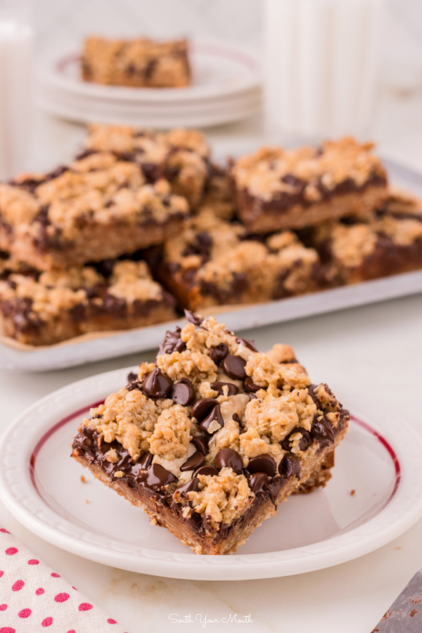 Chocolate Chip Peanut Butter Oatmeal Bars! An easy chocolate chip cookie bar recipe with peanut butter fudge sandwiched between an oatmeal cookie crumble layer, aka Oatmeal Dream Bars!