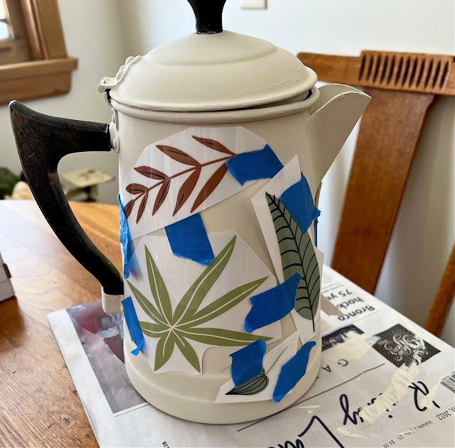 Photo of decor transfers taped on a coffeepot.