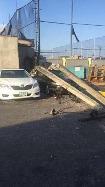 OMG!!! Many Escape Death as Electric Pole Falls and Smashes Car in Lagos (Photos)