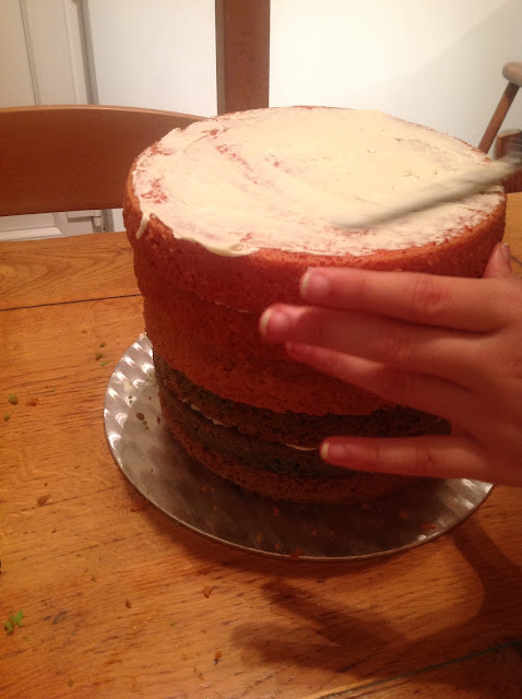 building and icing a rainbow cake