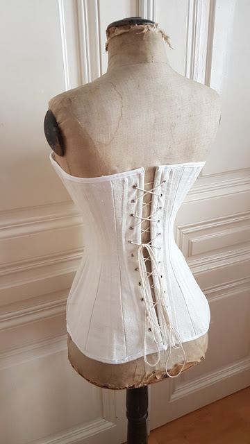 back/side view of the edwardian corset on an edwardian dress form