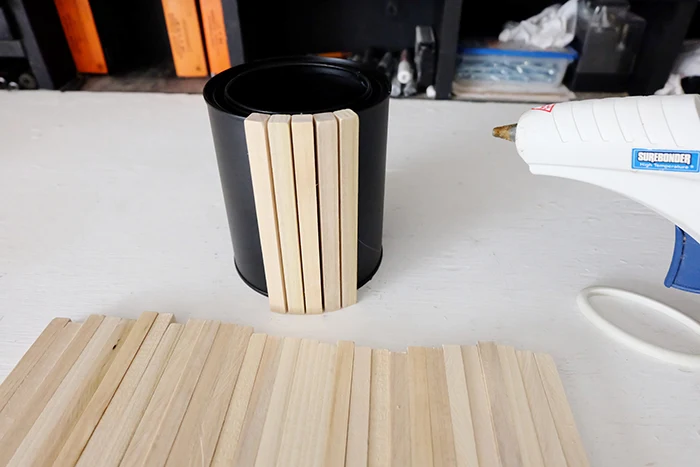 hot gluing dowels onto paint can