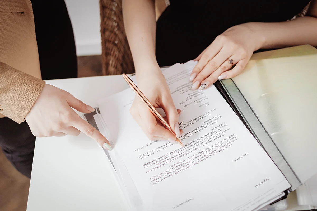 close-up of two women writting in a notebook