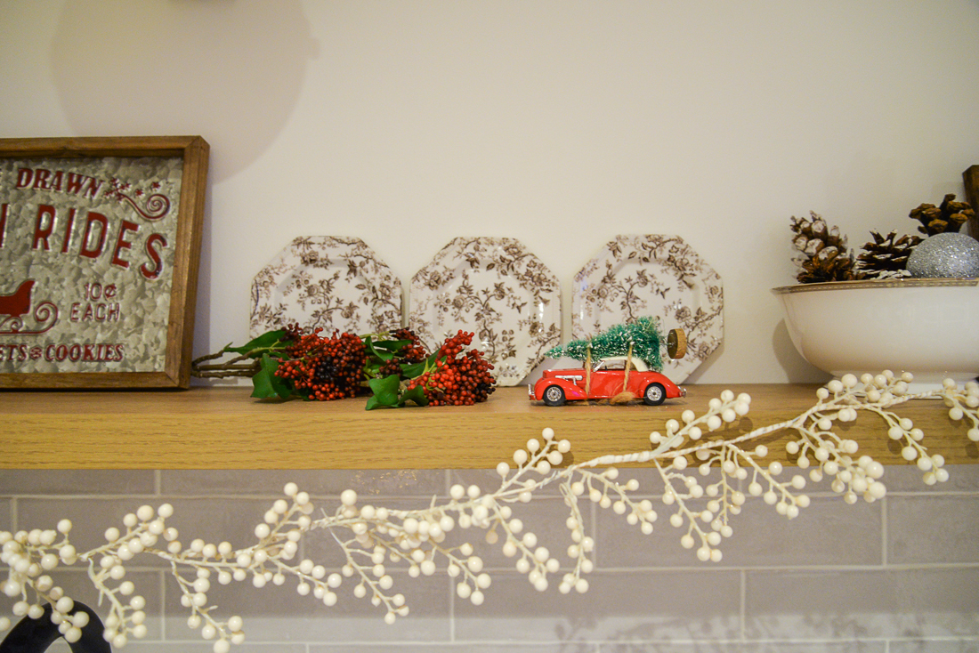 floating shelf with white berry garland and christmas signs