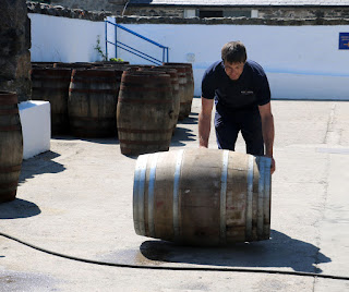 The Head Warehouseman rolls a barrel