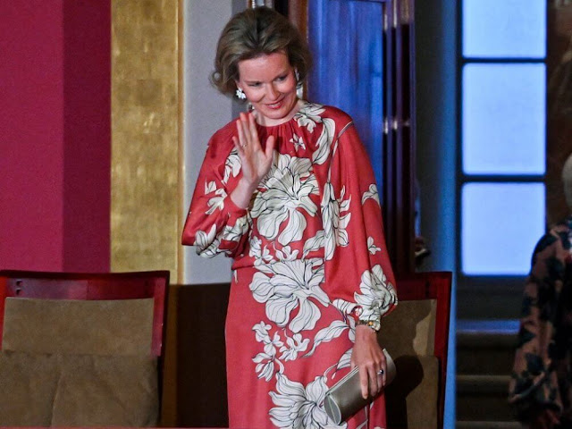 Queen Mathilde wore a new floral print long sleeve gown by Natan Couture. Armani clutch bag and Armani shoes