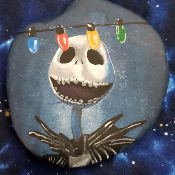 Use this Jack Skellington painted rock to inspire you to paint your own for Christmas