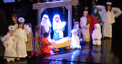 Children pose in a Christmas tableau