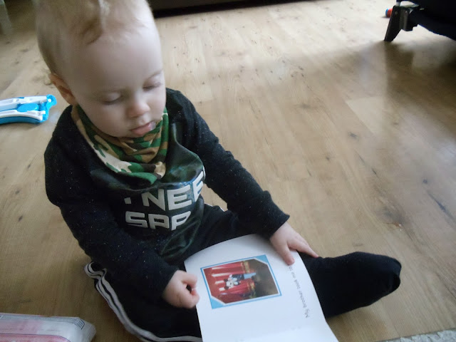 little boy holding a personalised photo book