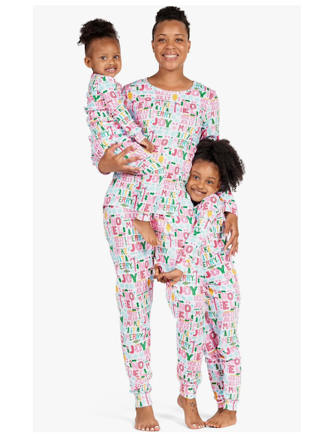 family wearing matching holiday christmas pajamas in pastel colors