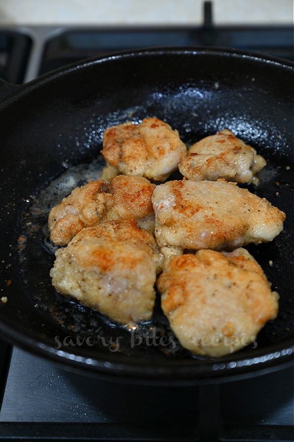 a cast iron pan with fried chicken