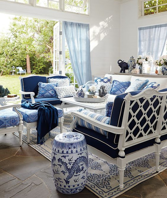 Gorgeous blue and white decorated sun room with chinoiserie stool - found on Hello Lovely Studio