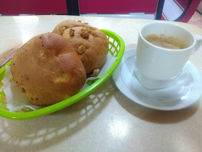 Pan chicharrón, or mogolla chicharron (bread filled with pork scratchings) with a dark (very dark!) perico (coffee with a dash of milk). Pure bliss!